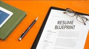 Resume blueprint on a clipboard with glasses and pen — how to write a resume that passes ATS